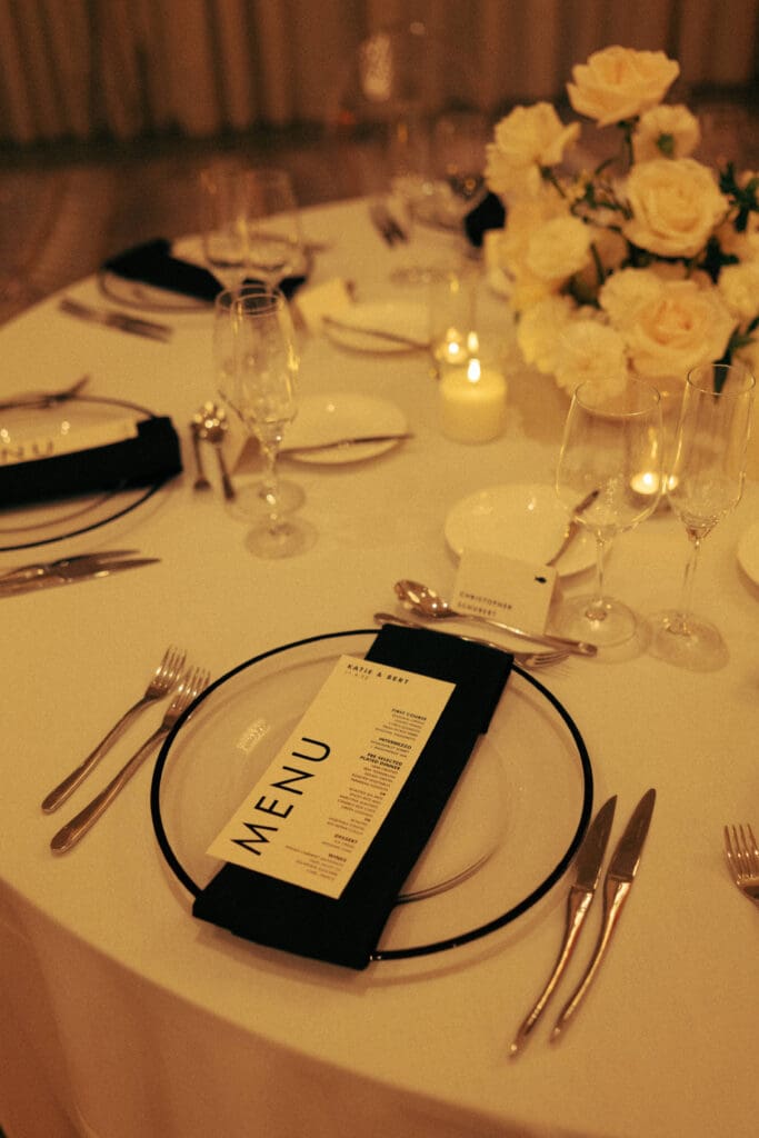 black and white place setting with transparent charger plate